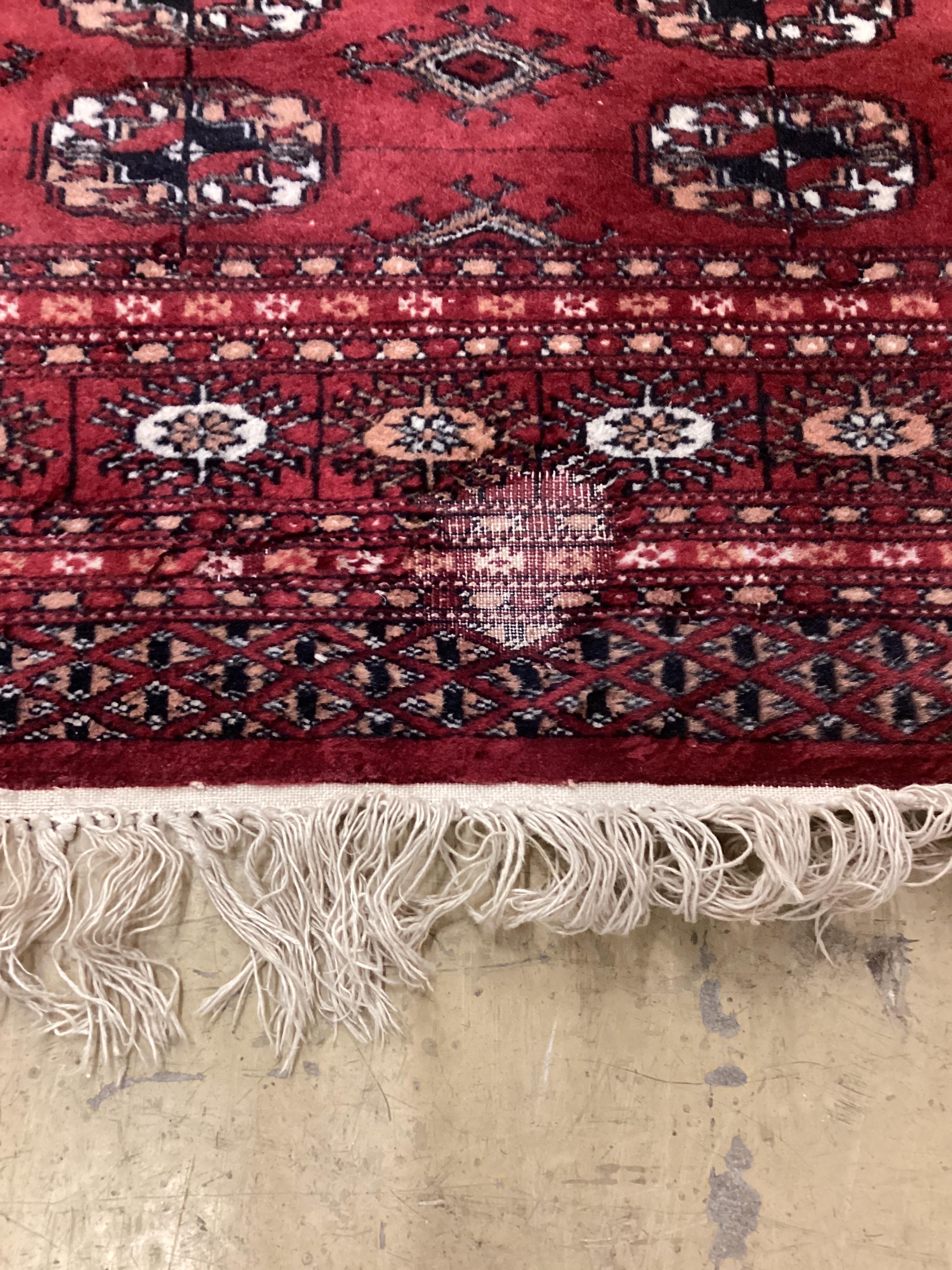 A Bokhara red ground rug, 145 x 120cm